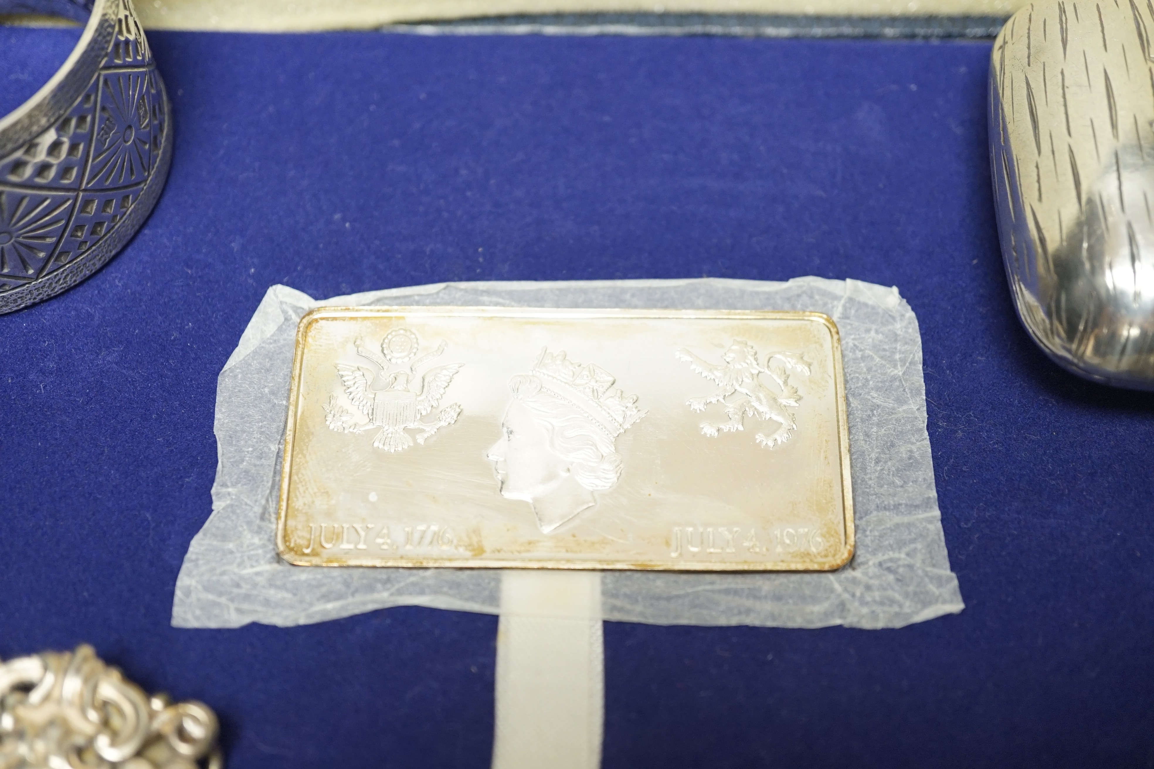 Small silver items including two napkin rings, a modern cased commemorative plaque and replica stamp, together with four white metal items including a Russian mounted purse.